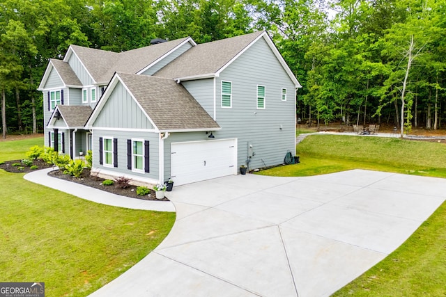 445 Boulder Crest Trl, Villa Rica, GA 30180 - view of side of home featuring board and batten siding, a shingled roof, a yard, concrete driveway, and view of wooded area