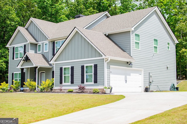445 Boulder Crest Trl, Villa Rica, GA 30180 - view of front of home featuring board and batten siding, a shingled roof, driveway, and a front lawn