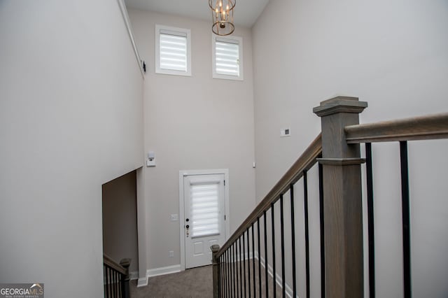 445 Boulder Crest Trl, Villa Rica, GA 30180 - staircase featuring a towering ceiling and carpet floors