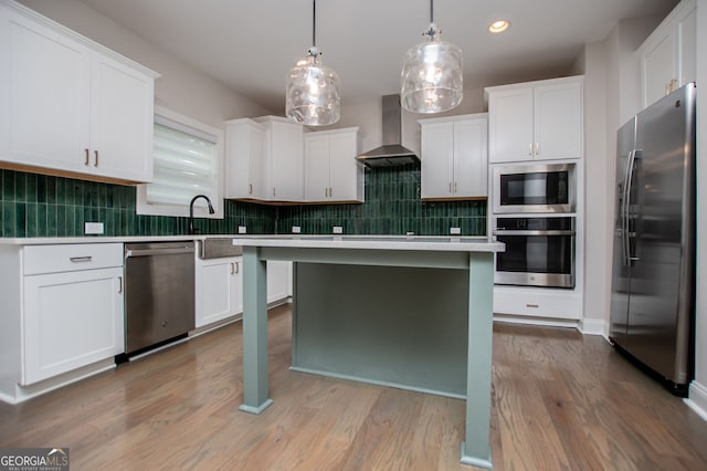 445 Boulder Crest Trl, Villa Rica, GA 30180 - kitchen with stainless steel appliances, wall chimney range hood, light countertops, white cabinets, and recessed lighting