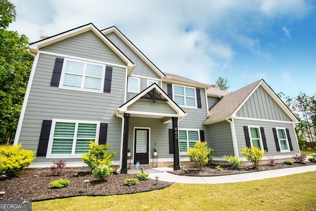 445 Boulder Crest Trl, Villa Rica, GA 30180 - view of front of house with board and batten siding, a front yard, and roof with shingles