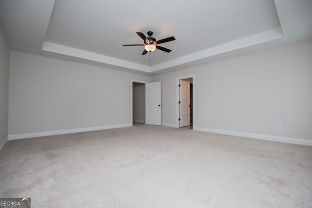 445 Boulder Crest Trl, Villa Rica, GA 30180 - spare room featuring a raised ceiling, a ceiling fan, and light carpet