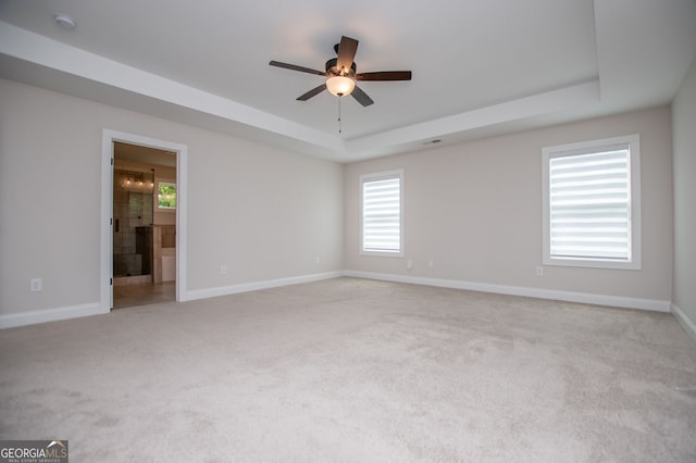 445 Boulder Crest Trl, Villa Rica, GA 30180 - spare room featuring a tray ceiling, light carpet, ceiling fan, a smoke detector, and plenty of natural light