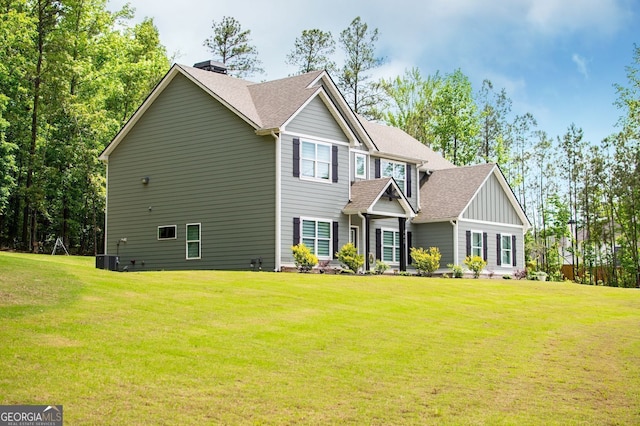 445 Boulder Crest Trl, Villa Rica, GA 30180 - view of front of home featuring a front yard, a shingled roof, board and batten siding, and a chimney