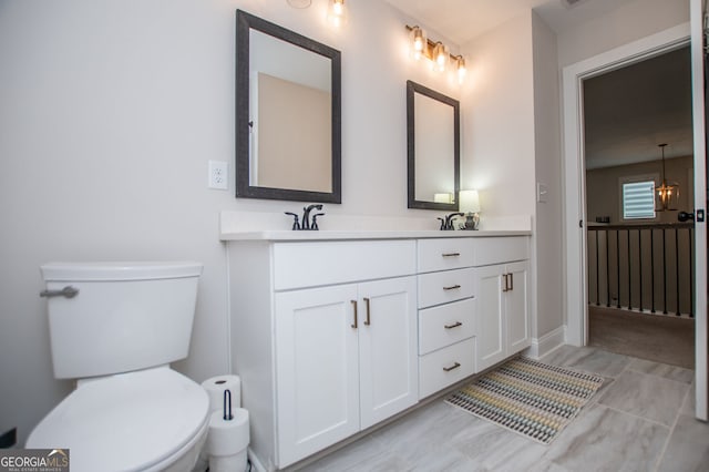 full bathroom featuring double vanity, a sink, and toilet