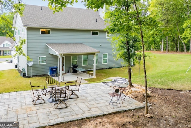445 Boulder Crest Trl, Villa Rica, GA 30180 - rear view of house with a lawn, a chimney, a patio area, and roof with shingles