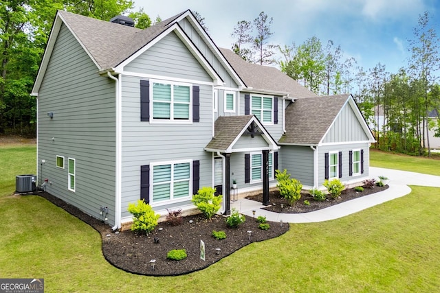 view of front of house with a front lawn, board and batten siding, roof with shingles, and cooling unit