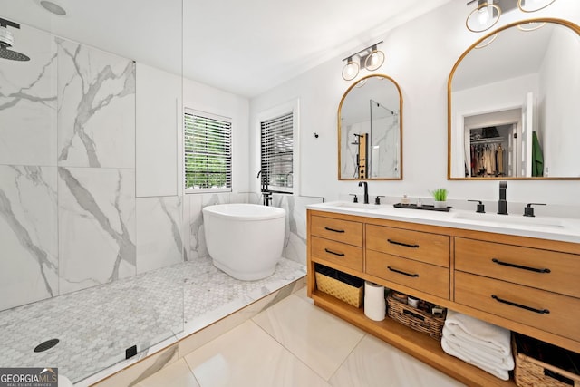 bathroom with double vanity, a marble finish shower, a sink, and a soaking tub