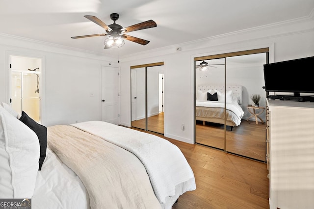 bedroom with two closets, a ceiling fan, ornamental molding, and light wood-style flooring