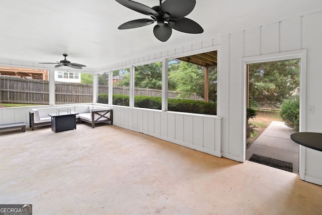 sunroom / solarium with a ceiling fan and a wealth of natural light