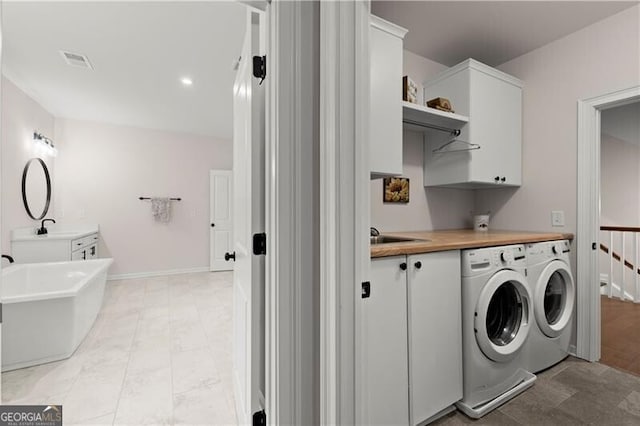 1074 Heyward Way, Alpharetta, GA 30009 - clothes washing area with cabinet space, a sink, separate washer and dryer, baseboards, and visible vents