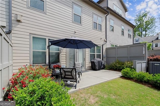 1074 Heyward Way, Alpharetta, GA 30009 - back of house with central air condition unit, fence, a lawn, and a patio area