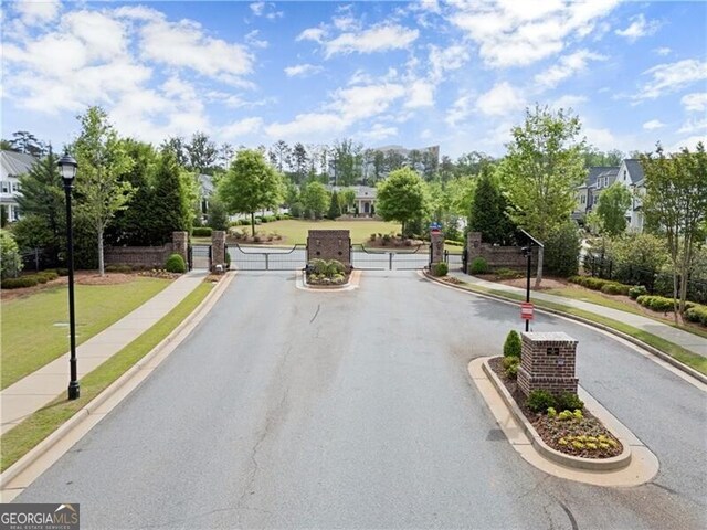 1074 Heyward Way, Alpharetta, GA 30009 - view of street featuring street lighting, curbs, a gate, sidewalks, and a gated entry