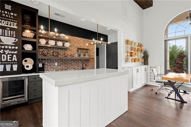 1074 Heyward Way, Alpharetta, GA 30009 - bar with visible vents, brick wall, beverage cooler, dark wood-style floors, and hanging light fixtures
