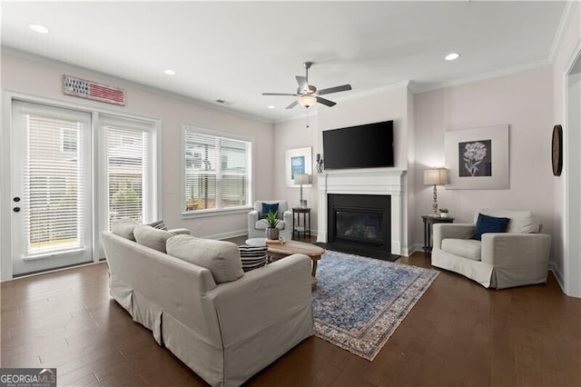 1074 Heyward Way, Alpharetta, GA 30009 - living room with ceiling fan, crown molding, a glass covered fireplace, recessed lighting, and dark wood-type flooring