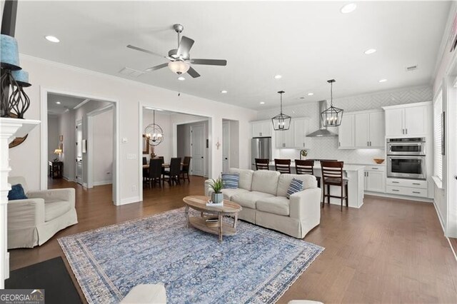 1074 Heyward Way, Alpharetta, GA 30009 - living area with baseboards, ceiling fan with notable chandelier, recessed lighting, and wood finished floors