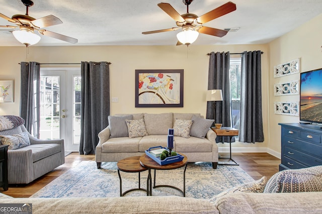 living room with visible vents, ceiling fan, and a healthy amount of sunlight