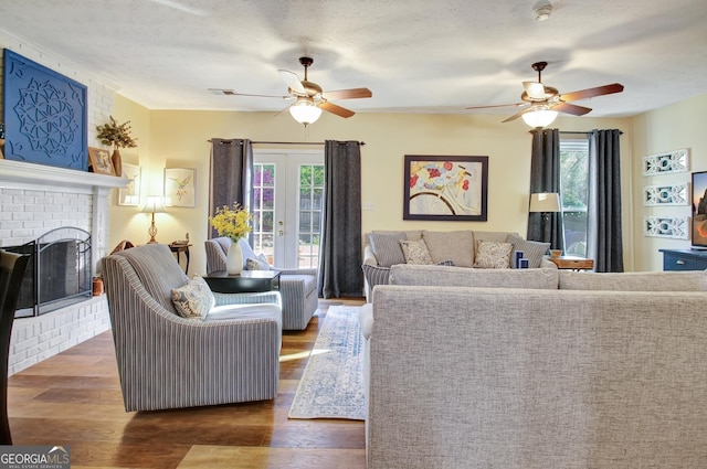 living area featuring plenty of natural light, ceiling fan, and wood finished floors