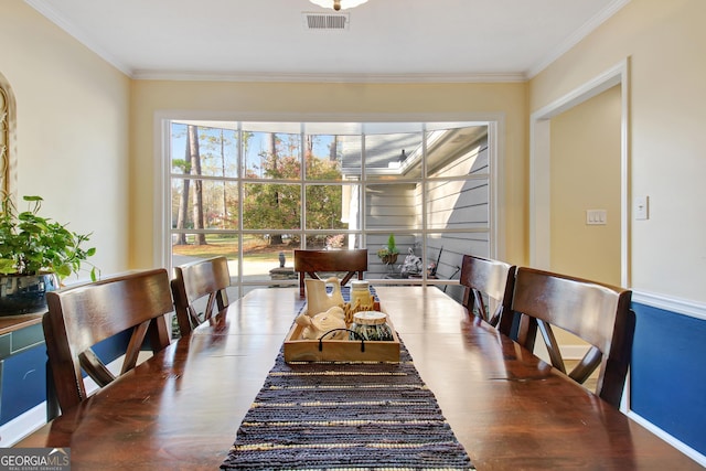 dining space with ornamental molding and visible vents