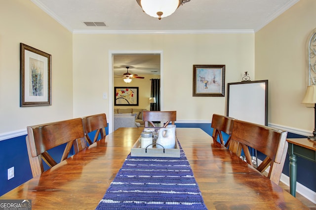 dining room with ceiling fan, visible vents, ornamental molding, and wood finished floors