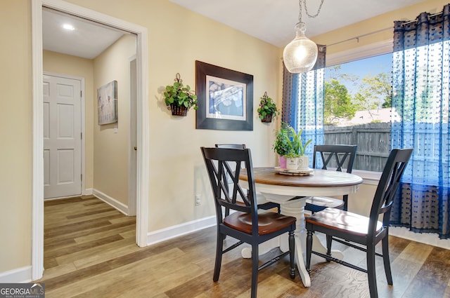 dining area featuring baseboards and wood finished floors