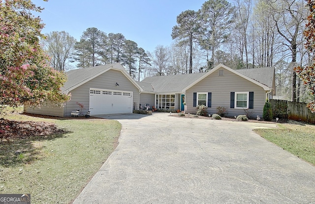 single story home with concrete driveway, fence, a front yard, and a garage