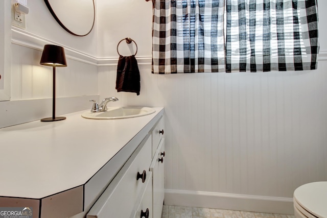 bathroom featuring vanity and toilet