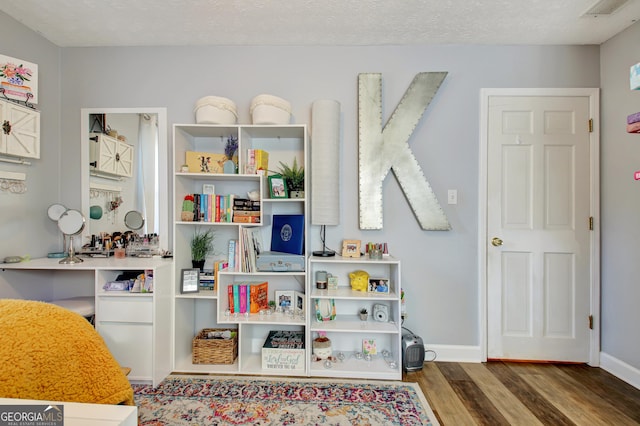 playroom featuring baseboards and wood finished floors