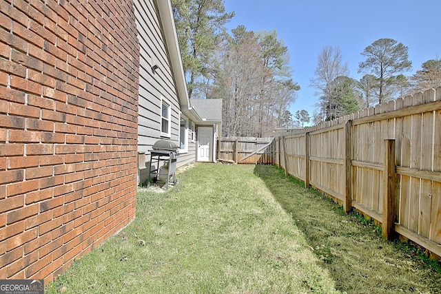 view of yard with a fenced backyard