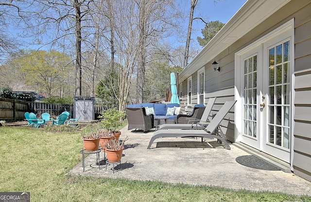 view of patio featuring fence and french doors