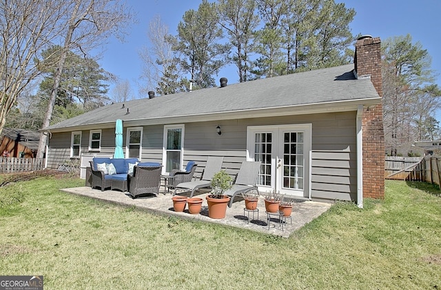 back of property with outdoor lounge area, fence, french doors, a chimney, and a patio area