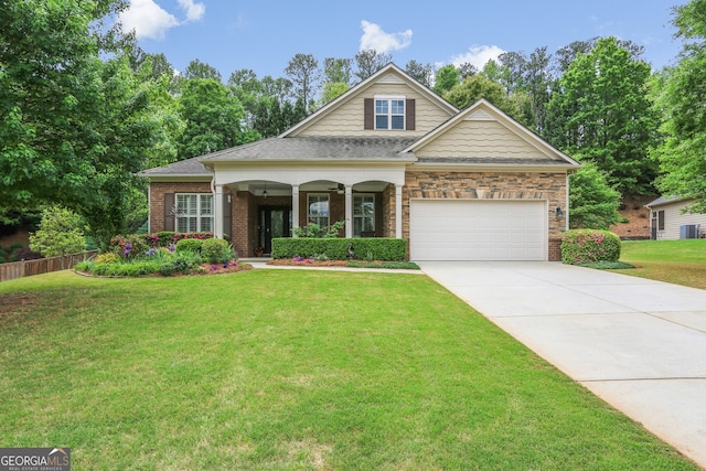 craftsman-style home featuring a garage, a front lawn, brick siding, a porch, and driveway