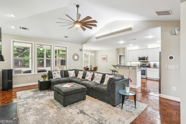 living area with ceiling fan, visible vents, baseboards, and lofted ceiling