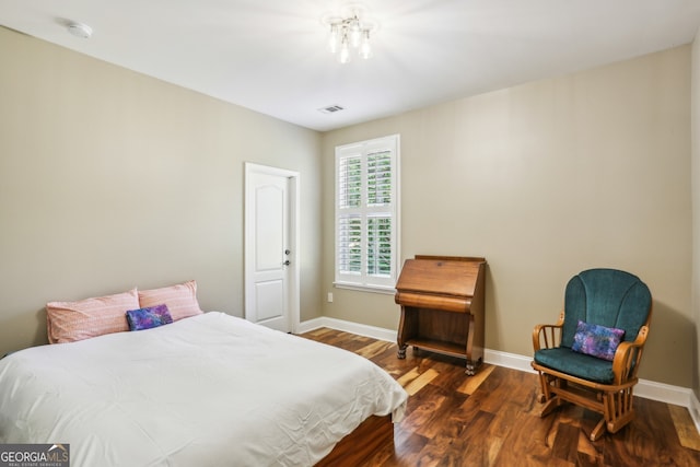bedroom featuring baseboards and wood finished floors
