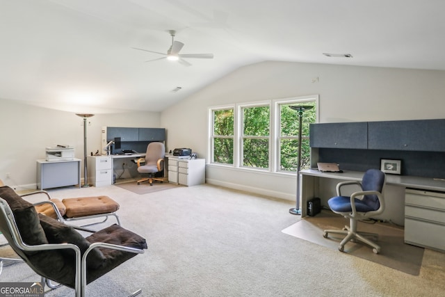 home office with visible vents, carpet flooring, ceiling fan, and vaulted ceiling