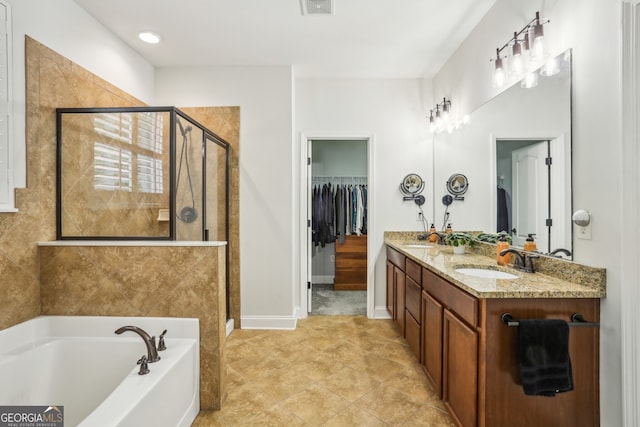 full bath featuring a sink, double vanity, a spacious closet, a bath, and a stall shower