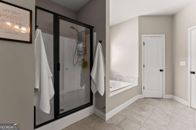 1929 Windstone Pl, Winder, GA 30680 - bathroom with a garden tub, tile patterned floors, baseboards, and a stall shower