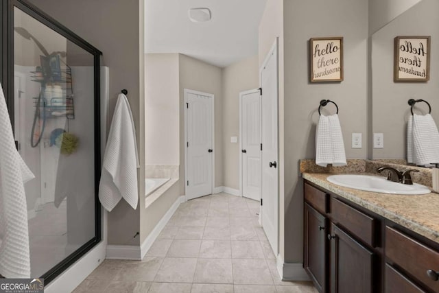 1929 Windstone Pl, Winder, GA 30680 - bathroom with a bath, tile patterned flooring, a stall shower, vanity, and baseboards
