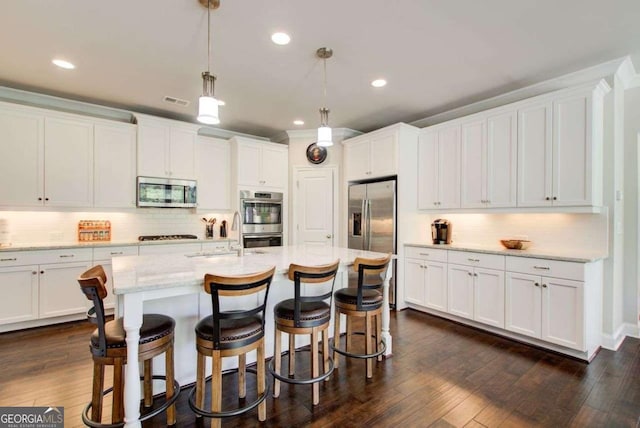 1040 Peyton View Ct, Alpharetta, GA 30004 - kitchen featuring a kitchen breakfast bar, white cabinets, a sink, appliances with stainless steel finishes, and backsplash