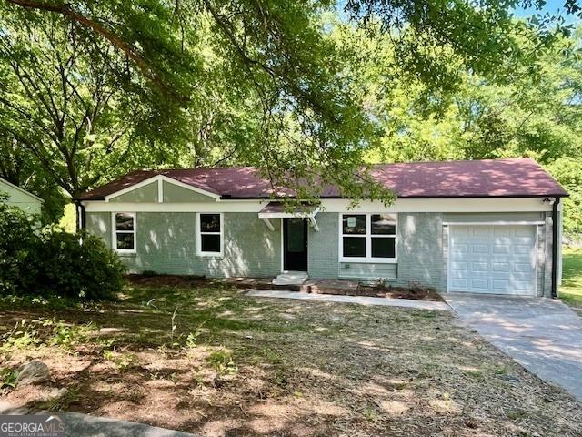 ranch-style home with an attached garage and driveway