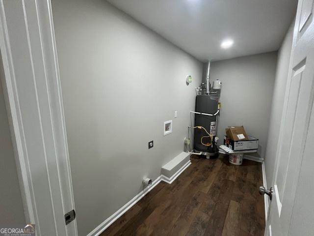 laundry room featuring laundry area, hookup for a washing machine, dark wood-type flooring, and secured water heater