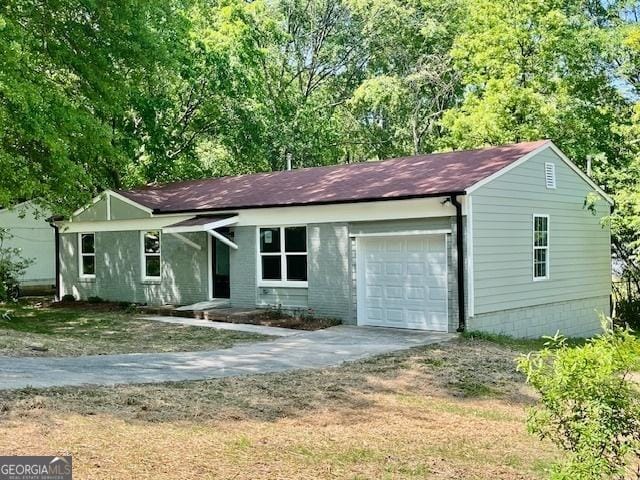 single story home with a garage and concrete driveway