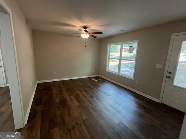 interior space featuring plenty of natural light, a ceiling fan, and dark wood finished floors