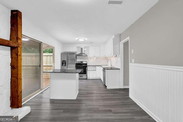 2551 Park Rd SE, Smyrna, GA 30080 - kitchen with wall chimney exhaust hood, white cabinetry, a sink, dark wood finished floors, and stainless steel appliances