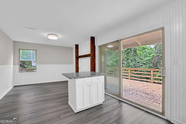 2551 Park Rd SE, Smyrna, GA 30080 - kitchen with visible vents, a wainscoted wall, white cabinets, and dark wood-style floors