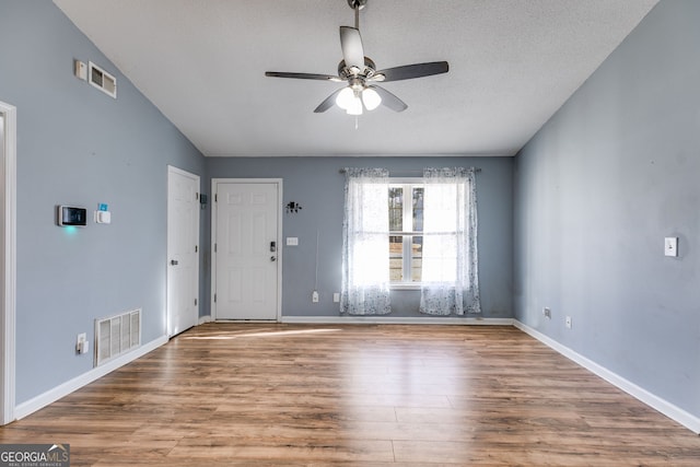 447 Wallace Way, Rockmart, GA 30153 - foyer entrance with ceiling fan, wood finished floors, baseboards, and vaulted ceiling