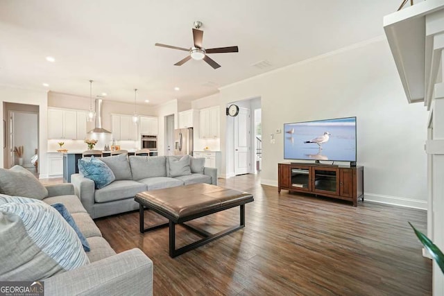 242 Fieldbrook Xing, Canton, GA 30115 - living area featuring a ceiling fan, crown molding, baseboards, recessed lighting, and dark wood-type flooring