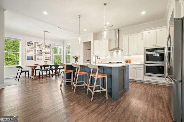 242 Fieldbrook Xing, Canton, GA 30115 - kitchen featuring wall chimney range hood, appliances with stainless steel finishes, tasteful backsplash, dark wood-style floors, and recessed lighting