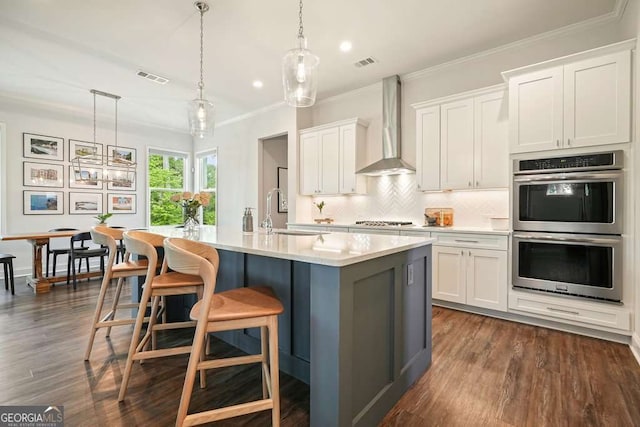 242 Fieldbrook Xing, Canton, GA 30115 - kitchen with a sink, light countertops, wall chimney exhaust hood, stainless steel appliances, and visible vents