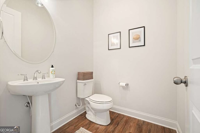 242 Fieldbrook Xing, Canton, GA 30115 - half bath featuring baseboards, wood finished floors, and toilet